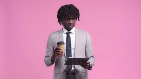 African american businessman with contract drinking coffee isolated on pink