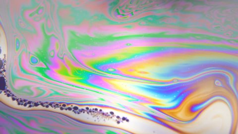 Dark colored bubbles moving in line, floating through rainbow liquid in pattern. Spirituality, hallucination concept