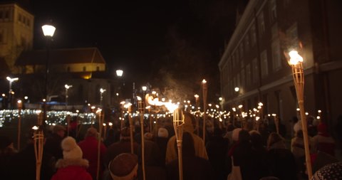 Torchlight procession protest march at night people with burning torches