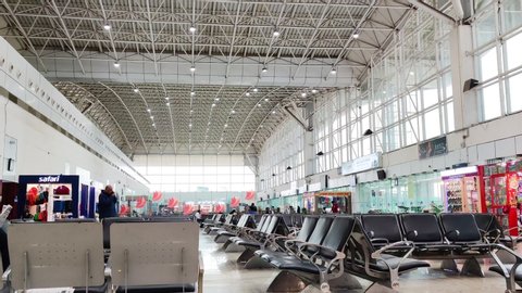 Ranchi, India - circa 2020: Panning shot of the waiting area in Ranchi jharkhand airport with metal seats chairs, shops from top brands, futuristic high glass roof. Situated in the capital of