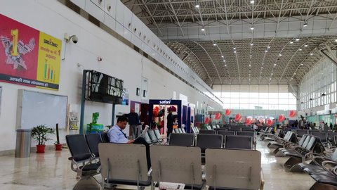 Ranchi, India - circa 2020: Panning shot of the waiting area in Ranchi jharkhand airport with metal seats chairs, shops from top brands, futuristic high glass roof. Situated in the capital of