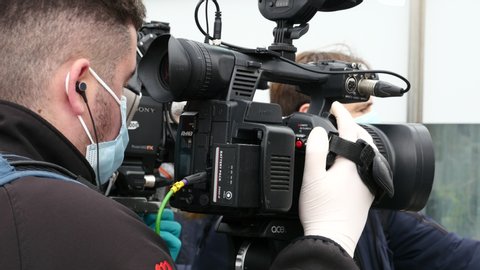 television camera operator protected with a mask by the state of alarm in Spain by the COVID-19. Filmed in Madrid on March 20, 2020.