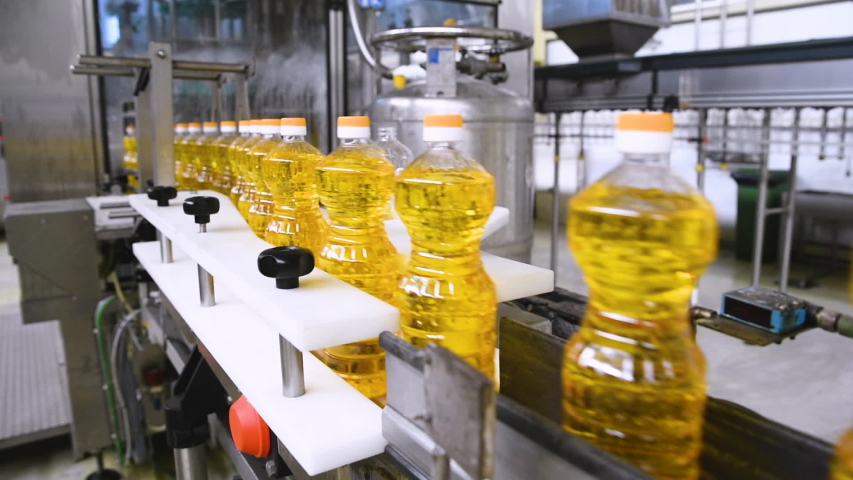 Sunflower oil in the bottle moving on production line. Sunflower oil   production factory Royalty-Free Stock Footage #1048708228