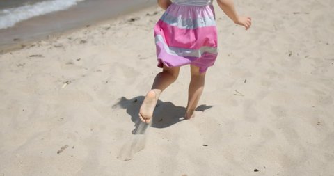 Happy little toddler running to runs on the sand on the beach. Happy Childhood Slow motion Video Stok