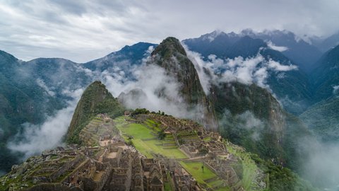 Time lapse view of mysterious Inca ruins at Machu Picchu shrouded in mist high in the Andes mountains, Cusco Region, Peru.