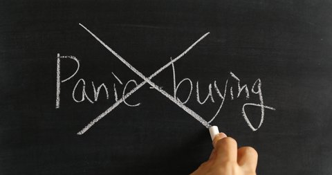 Drawing a X on "Panic buying" on blackboard to indicate that it is wrong
