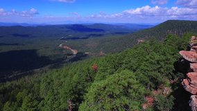 Aerial photography, Drone shot hanging off a cliff over a VALLEY of trees on a sunny day in the forest. Near the Mogollon Rim in Payson, AZ