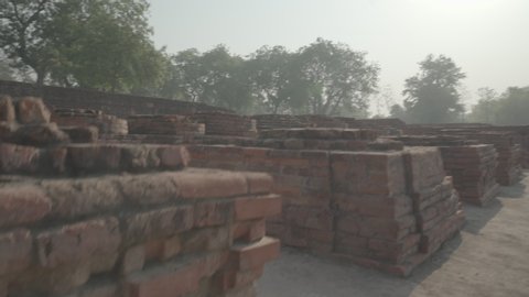 Shrines and votive stupa ruins alongside walkway to Mulgandha Kuty Vihara Sarnath