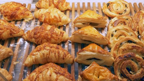 Croissant and Fresh French Bakery on Showcase in Supermarket. Golden Sweet and Cheese Buns
