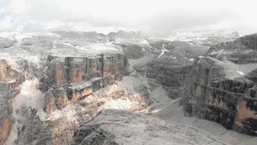 Stunning aerial footage of breathtaking mountain pass, abyss, cliffs, Italy, Dolomites, Sass Pordoi, Passo Pordoi, 4k