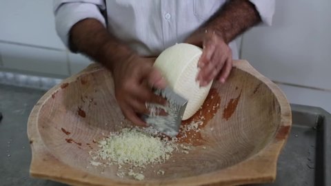 Close up of man's hand shaping the famous artisan cured cheese from Minas Gerais in wooden bowl. Concept of gourmet, food, cook, factory, healthy, organic and eat.