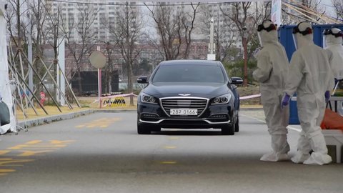 
Incheon, South Korea-March 21st. 2020
A suspected COVID-19 virus infection at Drive-Through Screening Clinic enters a car to be diagnosed and then examined.
