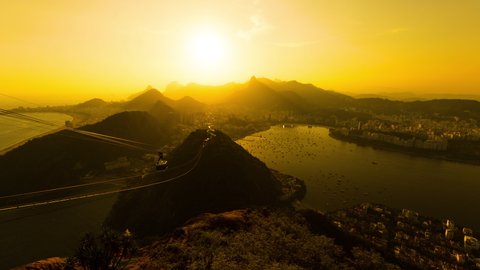 Day to night sunset timelapse of Rio de Janeiro, Brazil. Wide angle view of the mountains, city downtown, Ipanema, Copacabana, Mount Corcovado and the bay and ocean.