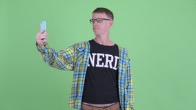Portrait of happy nerd man video calling with phone
