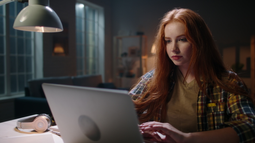 Positively surprised redhead caucasian girl looking at laptop, wing blowing her hair. Model reading breaking news, getting an amazing discount during online shopping or shocked by event 4k footage Royalty-Free Stock Footage #1048803304