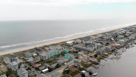 Aerial footage of Carolina Beach NC ocean waves, sand, and houses