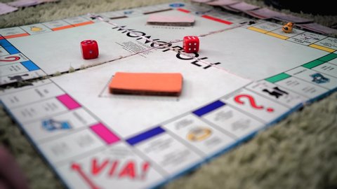 BOLOGNA, ITALY - MARCH 2020: Monopoly Board Game. The classic real estate trading game, Monopoly has become a part of international popular culture, having been licensed in more than 103 countries.