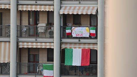 Turin, Piedmont, Italy. March 2020. Coronavirus pandemic. On the facades of the houses hang the sheets with the drawing of the rainbow and the message "everything will be fine".