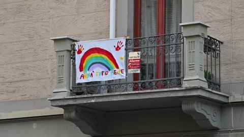 Turin, Piedmont, Italy. March 2020. Coronavirus pandemic. On the facades of the houses hang the sheets with the drawing of the rainbow and the message "everything will be fine".