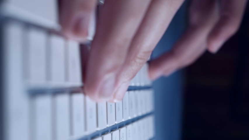 hands of a man typing on a keyboard, bussinesman, human close up look froma different foocus and point of view, vertical,  isolated indoors, techonology and work from home while quarantined concept