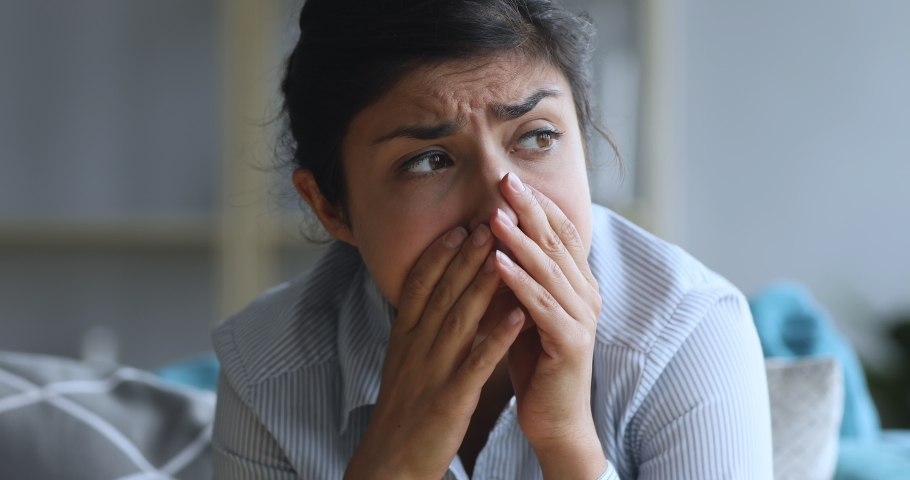 Head shot close up stressed young indian girl thinking of personal problem solution, suffering from tension head ache. Depressed worried millennial woman feeling insecure, regretting mistake. | Shutterstock HD Video #1048820518