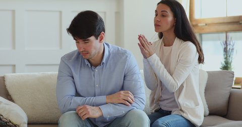 Funny guilty millennial girl pleading begging forgiveness for mistake. Young upset wife feeling remorse says sorry regrets for jealousy apologizing annoyed husband rejects to forgive. Apology concept