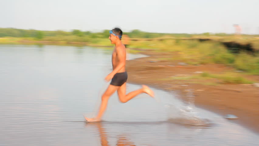 boy jumping in lake - slow motion