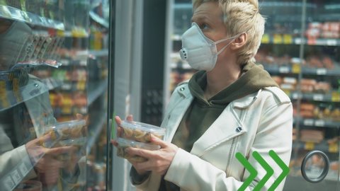 short haired blond woman in medical mask at the grocery store. pandemic.