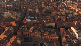 aerial view of bologna city center at sunrise tilt up drone flying over old town revealing shot