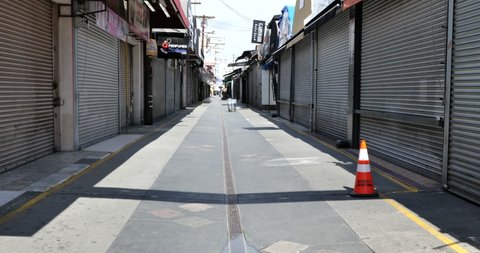 LOS ANGELES, CA/USA - MARCH 19, 2020:   The famous and normally crowded Santee Alley is boarded up and deserted the day prior to the Governor’s quarantine mandate
