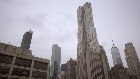 New York, NY / USA - Mar 12, 2020: "New York by Gehry" on 8 Spruce Street, originally knows as "Beekman Tower." Low angle view. Overcast day. No people.