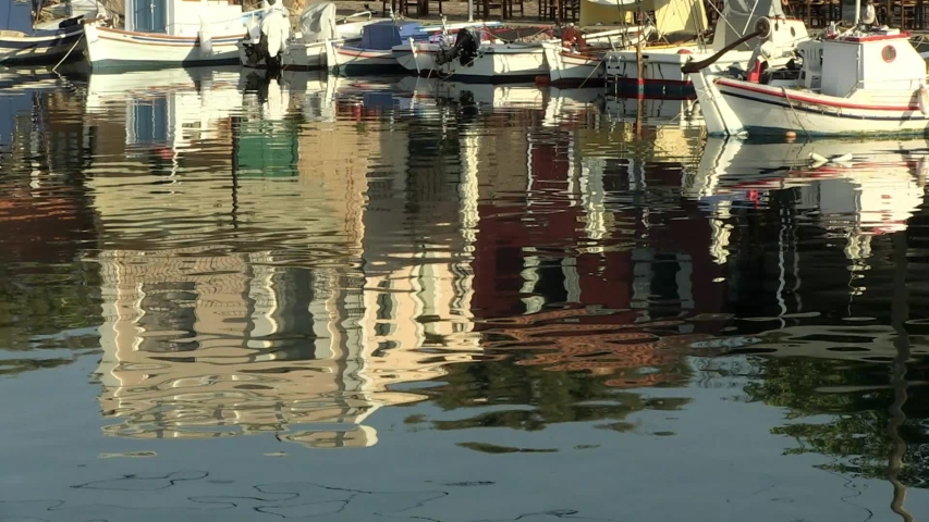 Small boats and reflections on the sea water at the port of Molyvos, Lesvos