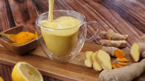 Immunity Boosting Antivirus Drink. Healthy Turmeric Latte Drink With Almond Milk In A Glass Cup. 