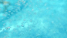 Bubbles rising to the surface. Air bubbles in water in swimming pool (underwater shot), good for backgrounds. Slow motion.