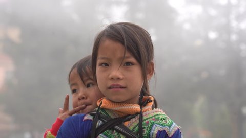 Sapa, Vietnam - march 03, 2020 : Ethnic Hmong young children on the street in Sapa region, North Vietnam
