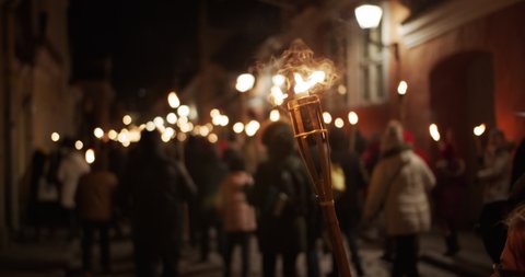 Torchlight procession protest march at night people walk with burning torches