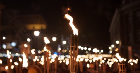 Torchlight procession protest march at night angry people with burning torches