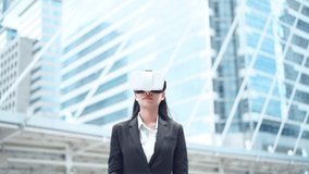 Business Asian female wearing virtual reality glasses using virtual business