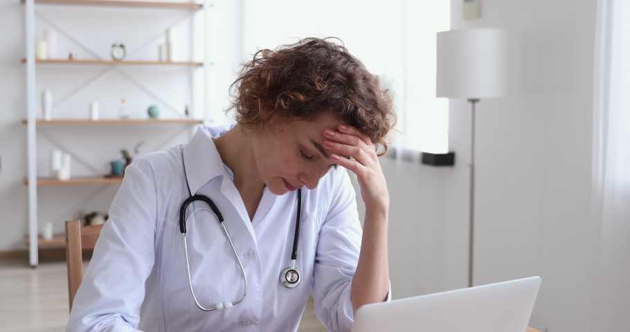 Upset young female doctor feeling tension, guilt blaming herself for professional mistake. Depressed worried woman therapist thinking of mental fatigue, anxious about tragic case at work concept. | Shutterstock HD Video #1048870807