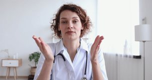 Professional female doctor talking looking at camera making conference video call. Physician speaking to web cam chatting with patient online providing remote e health medical assistance concept