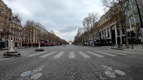 PARIS, FRANCE March 22th 2020 Empty Champs Elysées avenue because of containment measures due to the Covid-19 Coronavirus. View from of a rolling car