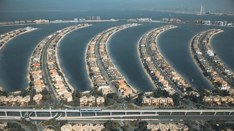 Aerial view of moving monorail train and fronds of the Palm Jumeirah island, United Arab Emirates