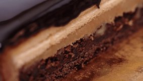 Close up chocolate frosting with gold foil garnish on delicious premium cake. macro, panning shot. Rack focus pulling  - Powered by Shutterstock - Get 15% off with code: PIKWIZARD15