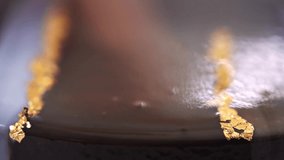 Close up chocolate frosting with gold foil garnish on delicious premium cake. macro, panning shot. - Powered by Shutterstock - Get 15% off with code: PIKWIZARD15