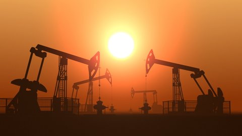Working oil pump jacks in a desert against sunset extracting crude oil. Pumping fossil oil is one of the methods of energy generation from renewable energy sources. Loopable animation.