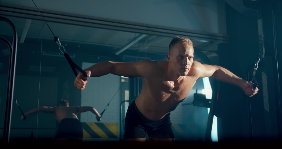 athletic man engage with crossover exercise in gym hard working