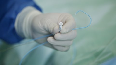 Close up on Surgeon hand during a heart catheterization