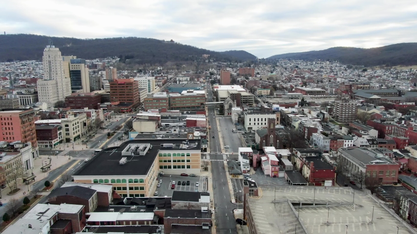Downtown Reading, PA, USA, urban city center, street, office buildings, traffic, church, businesses, aerial drone truck shot