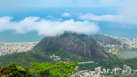 Aerial timelapse of the Copacabana and Ipanema in Rio de Janeiro, Brazil. View of the city and Morro hill with cloud passing over. Ocean and beach in the background.