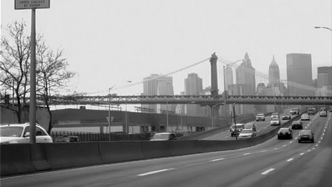 Cars Driving on the FDR Drive in Manhattan - New York City Skyline and Brooklyn Bridge - Black and White - 16mm Old Vintage Archival Style Film - NYC